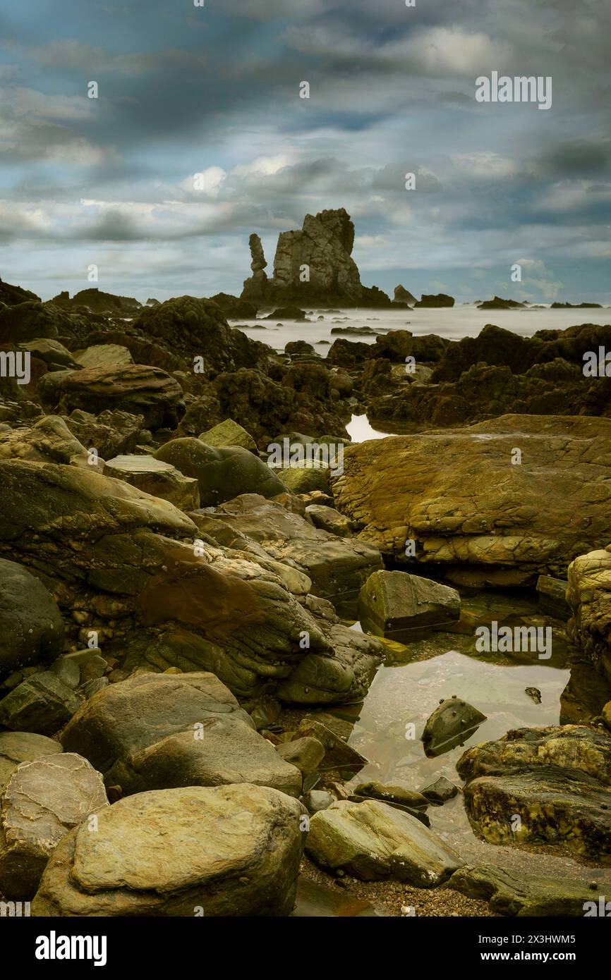 Sunset between the rocks at low tide on the shore of Playa del Silencio ...