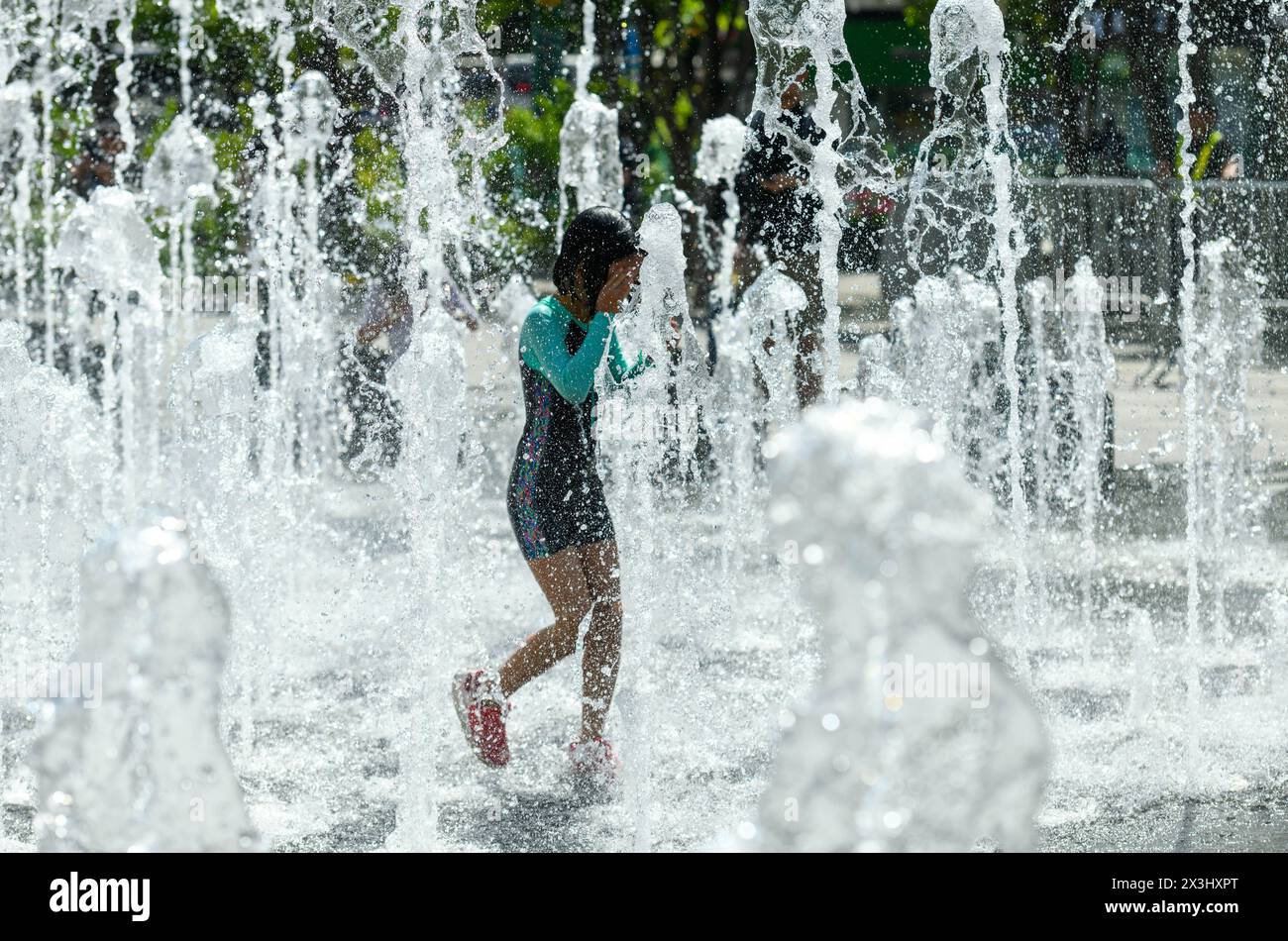 Seoul, South Korea. 27th Apr, 2024. A South Korean child plays with water at the fountain in the high temperature afternoon at Gwanghwamun Square in Seoul. On April 27, the temperature in Seoul is up to 26 degrees Celsius. (Photo by Kim Jae-Hwan/SOPA Images/Sipa USA) Credit: Sipa USA/Alamy Live News Stock Photo