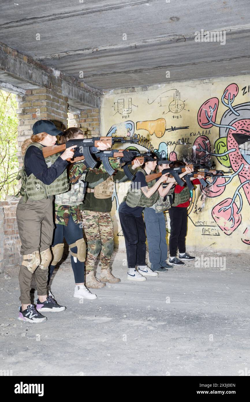 KYIV, UKRAINE - Apr. 13, 2024: Ukrainian civilian women practice with weapons as they attend training for women focused on use of weapons and combat medical kit amid the Russian invasion of Ukraine Stock Photo