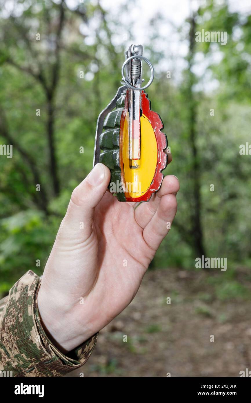 KYIV, UKRAINE - Apr. 13, 2024: Instructor shows structure of the grenade for ukrainian civilian women during the training focused on the use of weapons and combat medical kit amid the Russian invasion Stock Photo