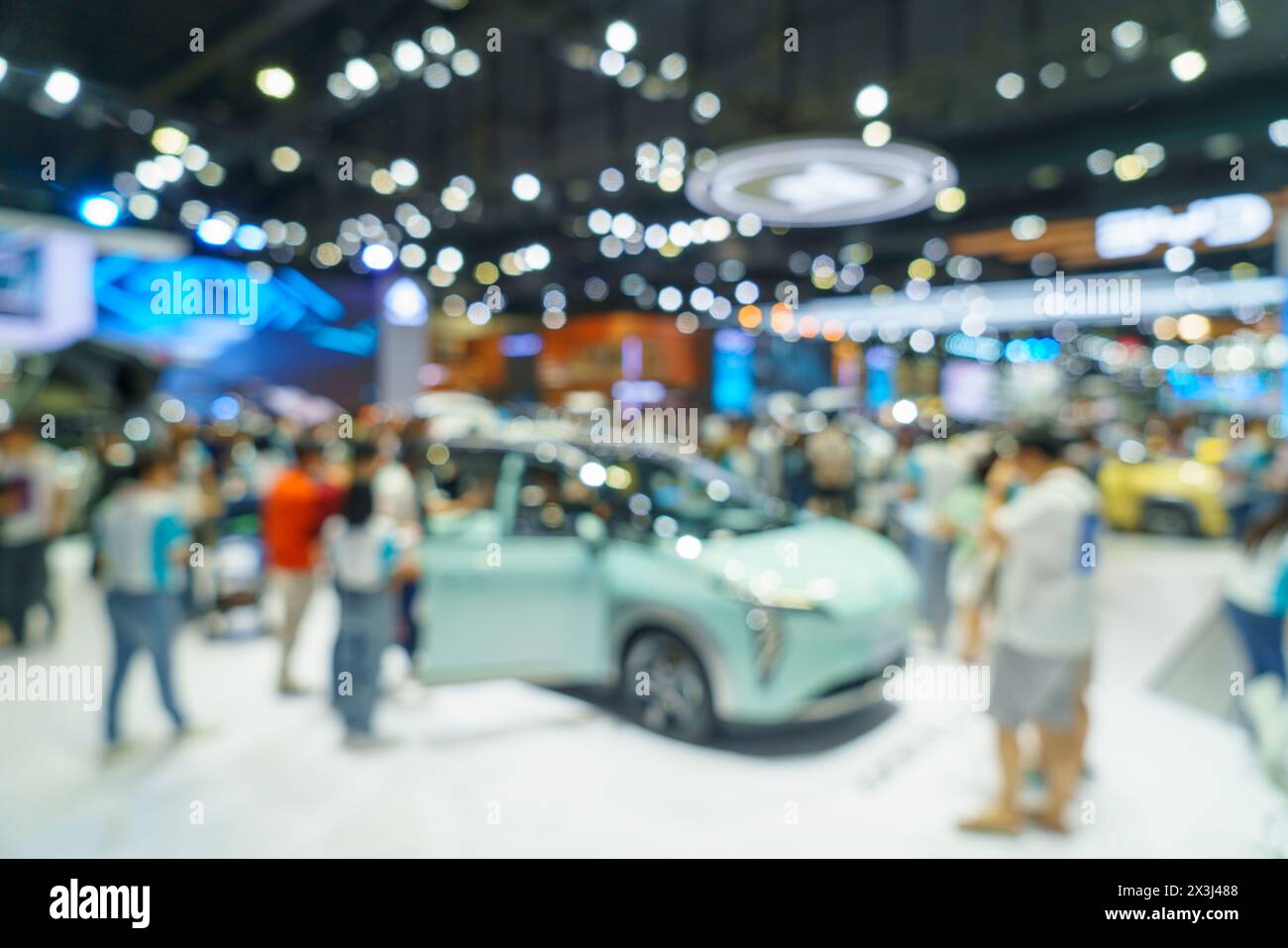 A modern car showroom. The soft focus highlights the sleek lines and vibrant colors of the displayed vehicles, making it an ideal background for autom Stock Photo