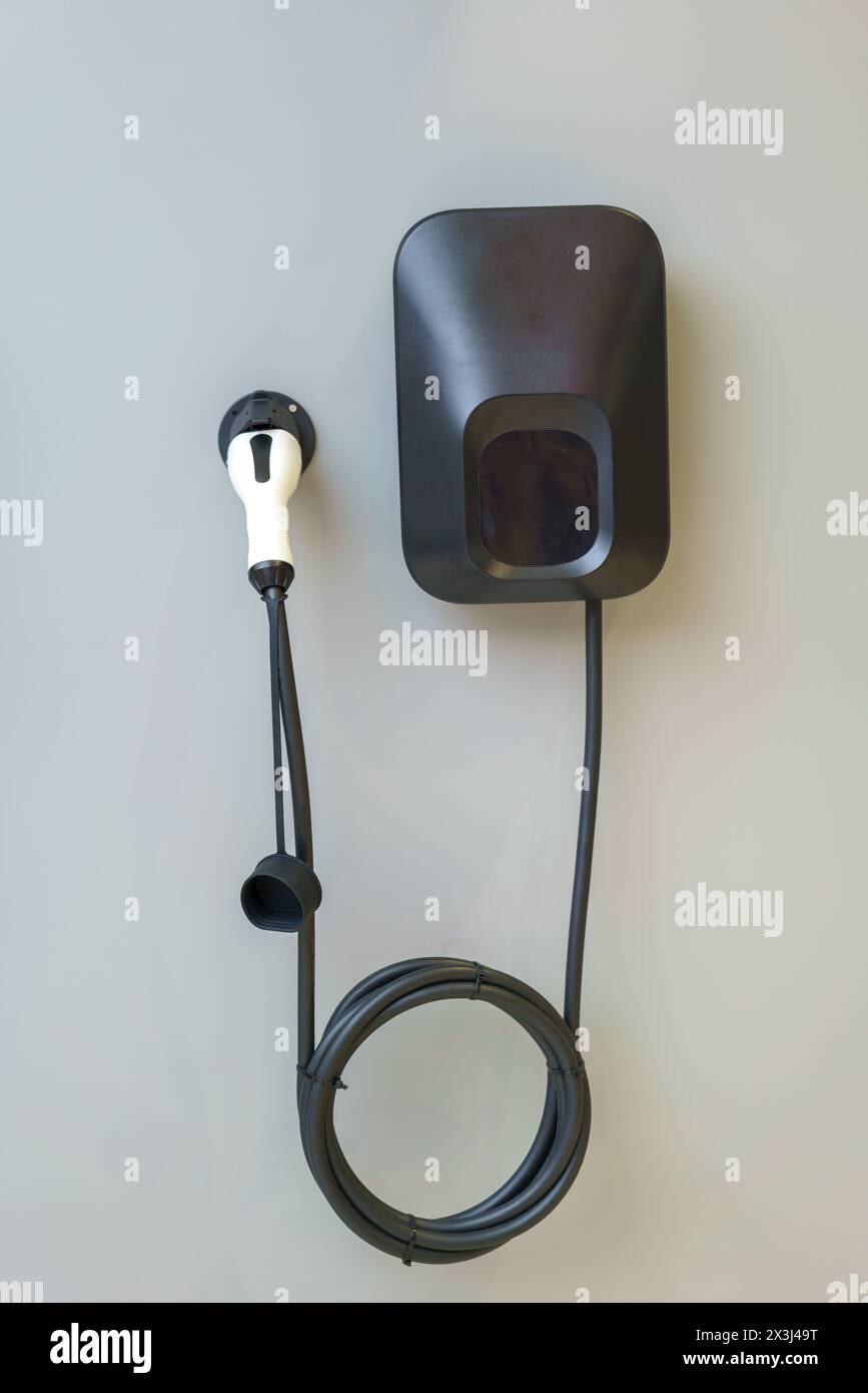 Convenience of charging your electric car at home with our reliable electric car charger. This sleek and efficient charger offers fast and convenient Stock Photo