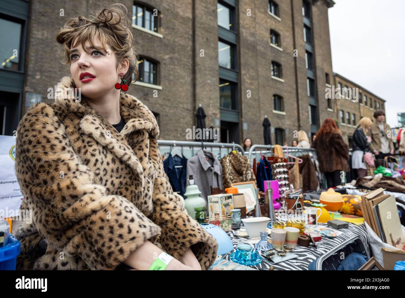 London, UK.  27 April 2024.  Stallholder Katie Smith of Damaged.Goods,Vintage at her stall at the Classic Car Boot Sale in Granary Square, King’s Cross.  The event celebrates all things vintage, from fashion and jewellery to homeware and vinyl records, against backdrop of vintage vehicles.   Credit: Stephen Chung / Alamy Live News Stock Photo
