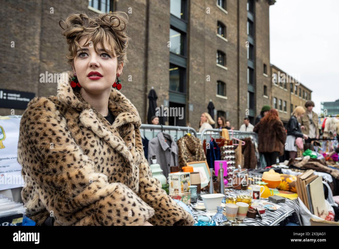 London, UK.  27 April 2024.  Stallholder Katie Smith of Damaged.Goods,Vintage at her stall at the Classic Car Boot Sale in Granary Square, King’s Cross.  The event celebrates all things vintage, from fashion and jewellery to homeware and vinyl records, against backdrop of vintage vehicles.   Credit: Stephen Chung / Alamy Live News Stock Photo