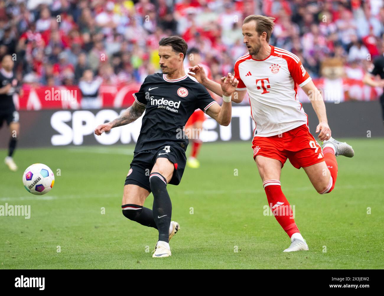 Munich, Germany. 27th Apr, 2024. Soccer: Bundesliga, Bayern Munich - Eintracht Frankfurt, matchday 31 at the Allianz Arena. Harry Kane (r) of Munich and Robin Koch of Frankfurt fight for the ball. Credit: Sven Hoppe/dpa - IMPORTANT NOTE: In accordance with the regulations of the DFL German Football League and the DFB German Football Association, it is prohibited to utilize or have utilized photographs taken in the stadium and/or of the match in the form of sequential images and/or video-like photo series./dpa/Alamy Live News Stock Photo