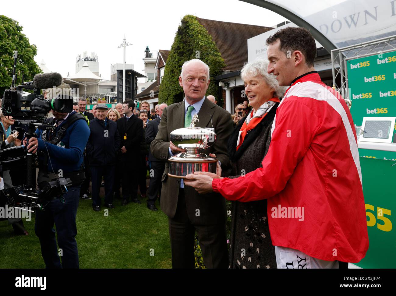 Winning trainer Willie Mullins poses with the Champion Trainer trophy alongside wife Jackie Mullins after Minella Cocooner won the bet365 Gold Cup Handicap Chase on bet365 Jump Finale day at Sandown Park Racecourse, Esher. Picture date: Saturday April 27, 2024. Stock Photo