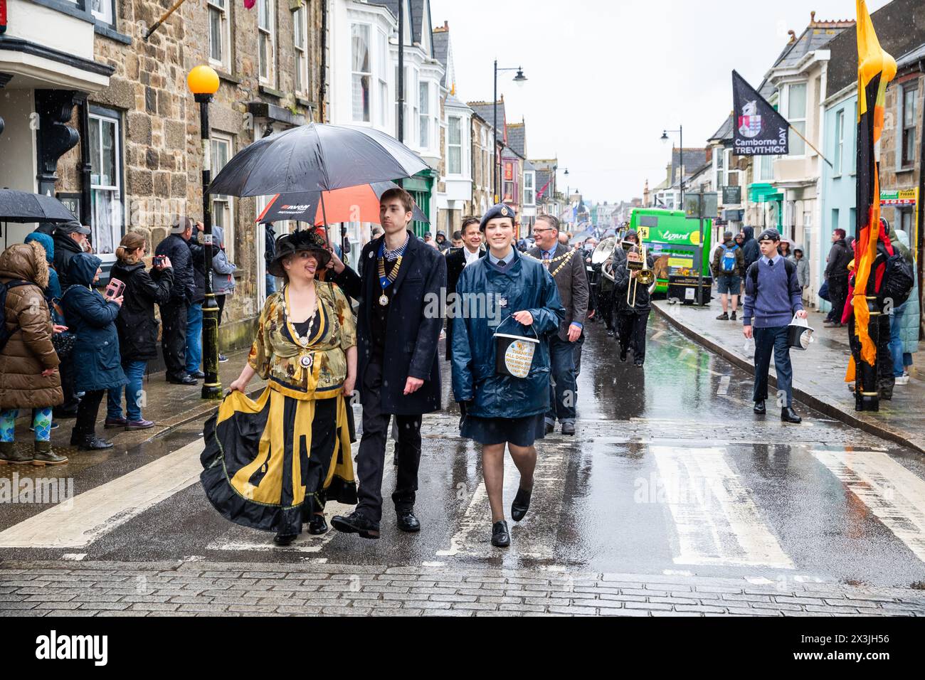 Camborne, Cornwall, UK. 27th Apr, 2024. Despite heavy rainfall, Trevithick Day celebrations continued. The event which drew about 25-35,000 people started early morning with Kernow Pipes and Drummers procession followed by a Bal Maiden and Miners Children's Dance. In the afternoon there was an adults Trevithick dance followed by the main event of the day which was a large parade of Steam Traction Engines. Credit: Keith Larby/Alamy Live News Stock Photo