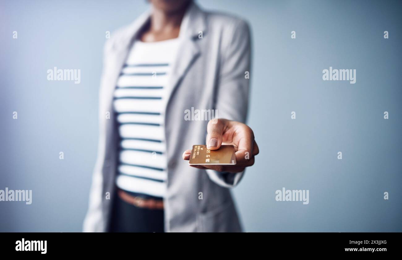 Business woman, hand and payment with credit card in online shopping, transaction or tap on a gray studio background. Closeup of female person Stock Photo