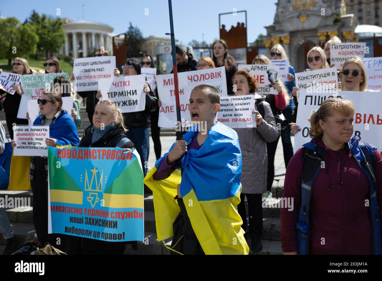 Kyiv, Ukraine. 27th Apr, 2024. Relatives of currently enlisted Ukrainian servicemen hold placards during a rally calling for demobilization terms to be set up, at the Independence Square in Kyiv. People gathered to demand the terms of length of service in the army, being on the frontline, and fair rotation. The demobilization terms are not prescribed in a new mobilization law which was adopted by the Ukrainian Parliament and signed by President Zelensky recently. Credit: SOPA Images Limited/Alamy Live News Credit: SOPA Images Limited/Alamy Live News Stock Photo