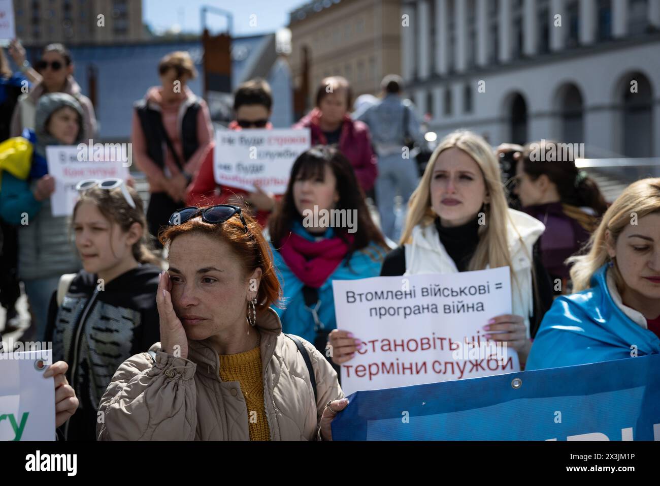 Kyiv, Ukraine. 27th Apr, 2024. Relative of currently enlisted Ukrainian serviceman holds a placard saying 'Set clear deadlines!' and 'A day on a frontline is not equal to one day of civilian life' during the rally calling for demobilization terms to be set up, at the Independence Square in Kyiv. People gathered to demand the terms of length of service in the army, being on the frontline, and fair rotation. Credit: SOPA Images Limited/Alamy Live News Stock Photo