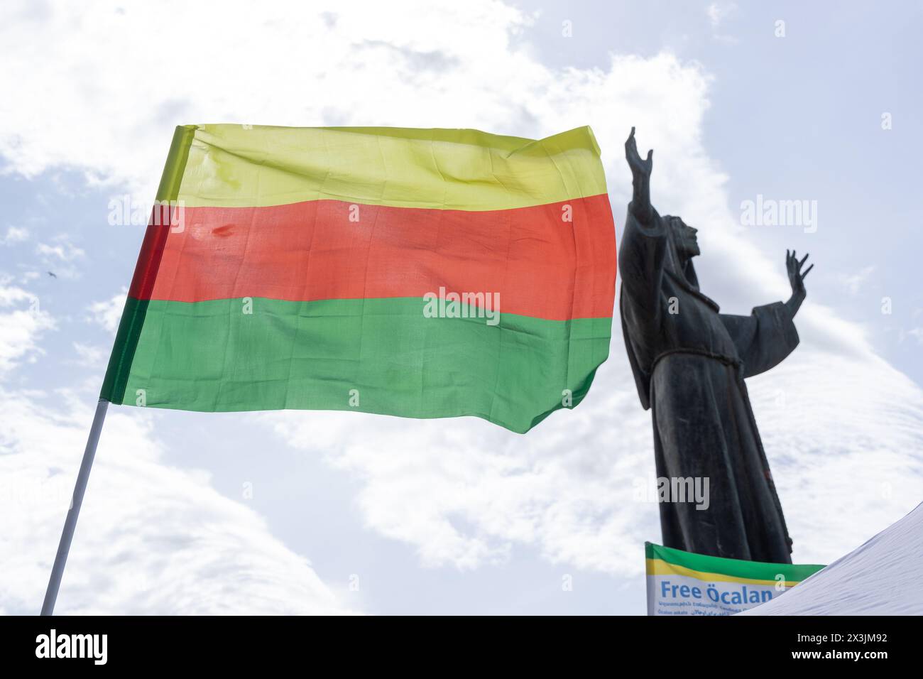 Rome, Italy. 27th Apr, 2024. Kurdish flag of Rojava flies in front of the statue of Saint Francis of Assisi at Piazza San Giovanni in Rome (Credit Image: © Matteo Nardone/Pacific Press via ZUMA Press Wire) EDITORIAL USAGE ONLY! Not for Commercial USAGE! Stock Photo