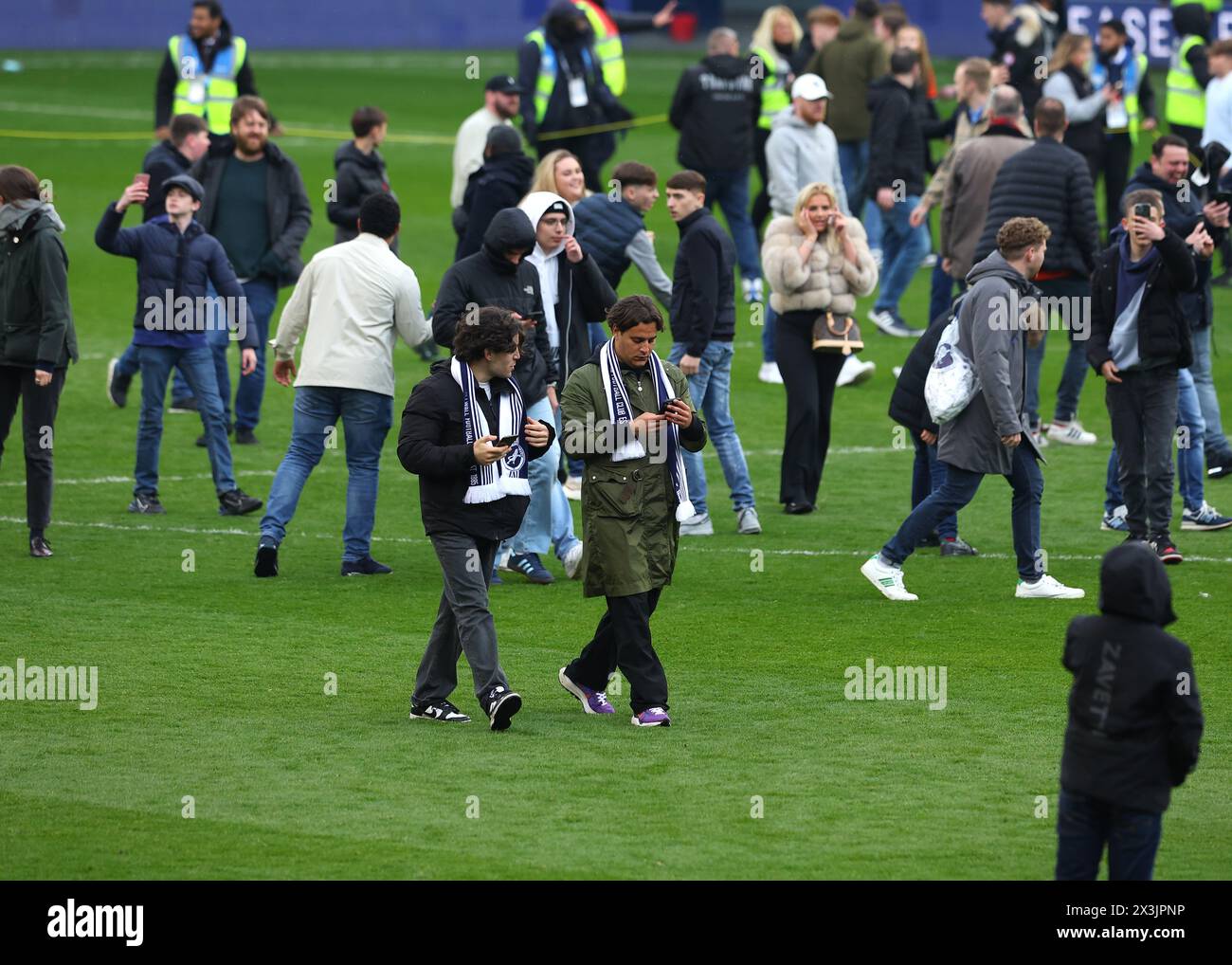 The Den, Bermondsey, London, UK. 27th Apr, 2024. EFL Championship Football, Millwall versus Plymouth Argyle; Millwall fans invading the pitch while ignoring the Please Keep Off the Pitch At All Times displayed on the scoreboard after full time Credit: Action Plus Sports/Alamy Live News Stock Photo