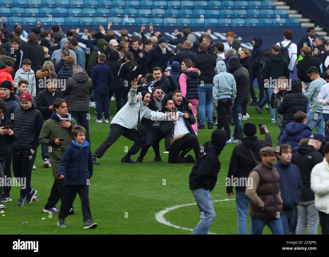 The Den, Bermondsey, London, UK. 27th Apr, 2024. EFL Championship Football, Millwall versus Plymouth Argyle; Millwall fans invading the pitch while ignoring the Please Keep Off the Pitch At All Times displayed on the scoreboard after full time Credit: Action Plus Sports/Alamy Live News Stock Photo