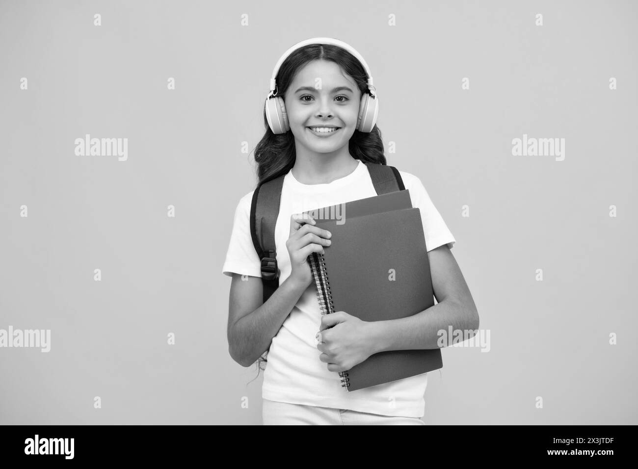 Back to school. Schoolgirl student in headphones with school bag ...