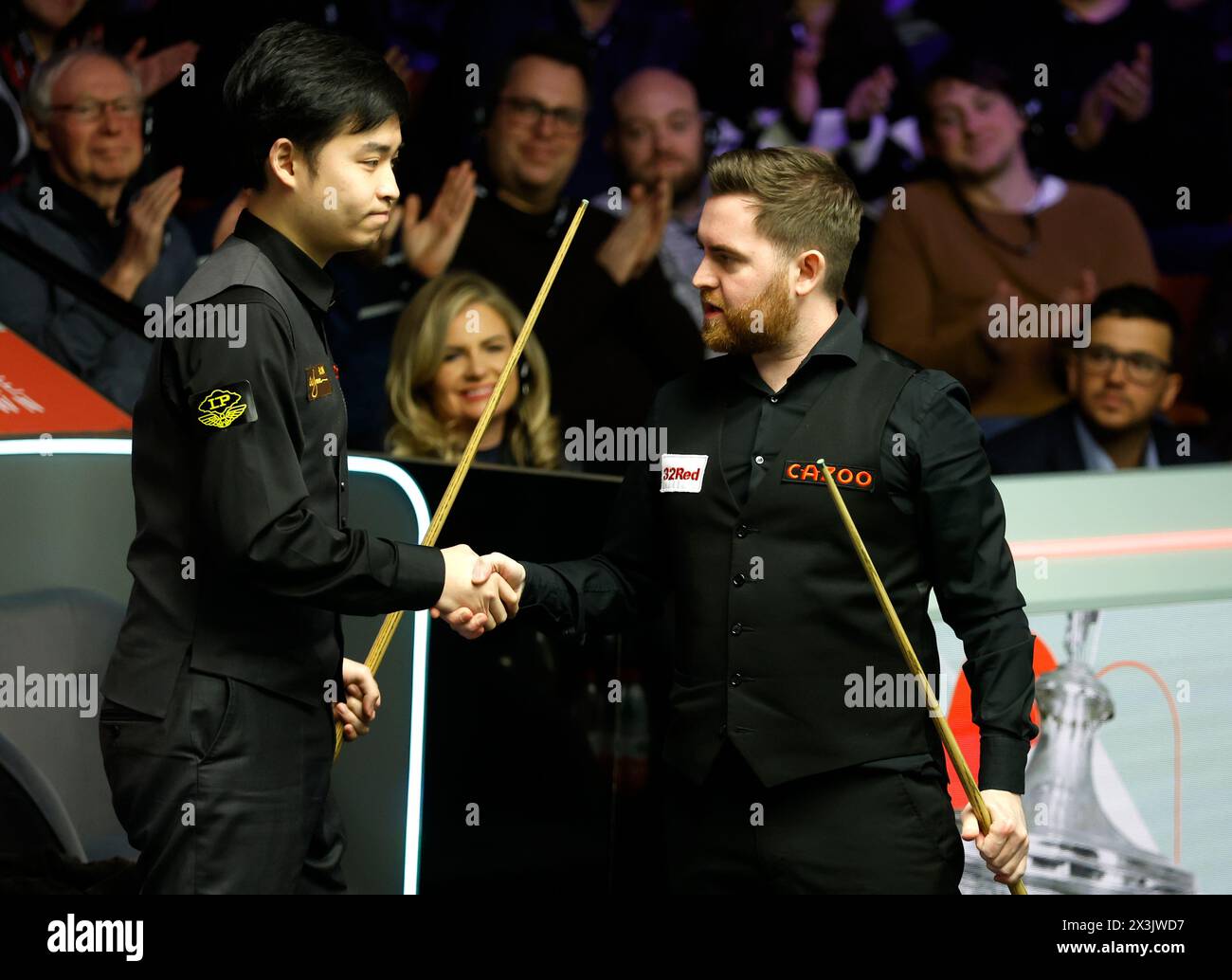 Jak Jones is congratulated by Si Jiahui on day eight of the 2024 Cazoo World Snooker Championship at the Crucible Theatre, Sheffield. Picture date: Saturday April 27, 2024. Stock Photo