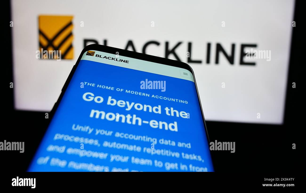 Smartphone with webpage of US enterprise software company BlackLine Systems Inc. in front of business logo. Focus on top-left of phone display. Stock Photo