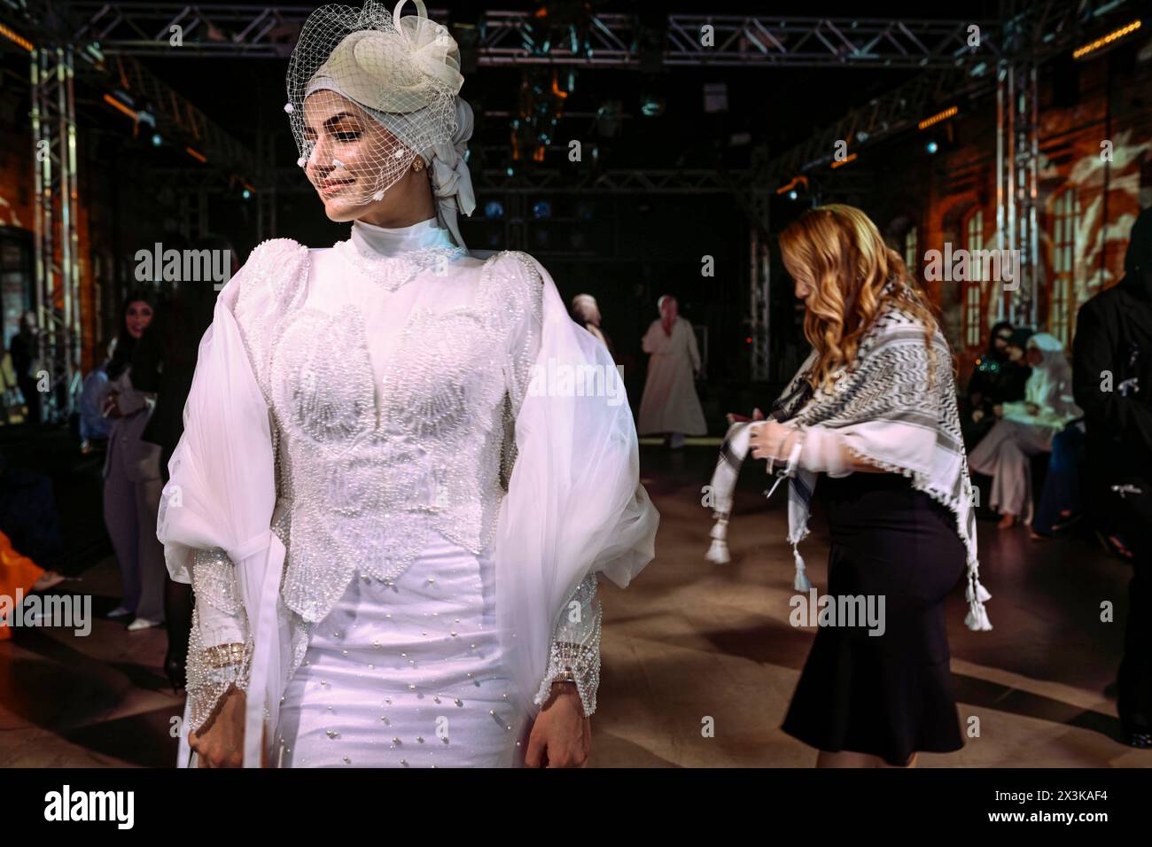 Istanbul, Turkey. 26th Apr, 2024. A lady seen wearing a bridal dress after the parade show. On the second day of the Istanbul Modest Fashion Week 2024, the Turkish brand Terzi Dukkani and Serpil, the Palestinian Sineen Haute Couture, the American Citizens of the World, the Nigerian Africa Abaya, and Bangladesh Niharika Momtaz presented their collections in the parade show of Istanbul Modest Fashion Week 2024 in Fisekhane Gallery, Istanbul. (Photo by Valeria Ferraro/SOPA Images/Sipa USA) Credit: Sipa USA/Alamy Live News Stock Photo