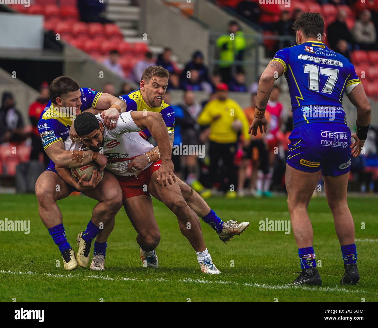 Salford, Manchester, UK. 27th April, 2024. Super League Rugby: Salford Red Devils Vs Warrington Wolves at Salford Community Stadium. NENE MACDONALD is tackled by MATT DUFTY AND DANNY WALKER. Credit James Giblin/Alamy Live News. Stock Photo
