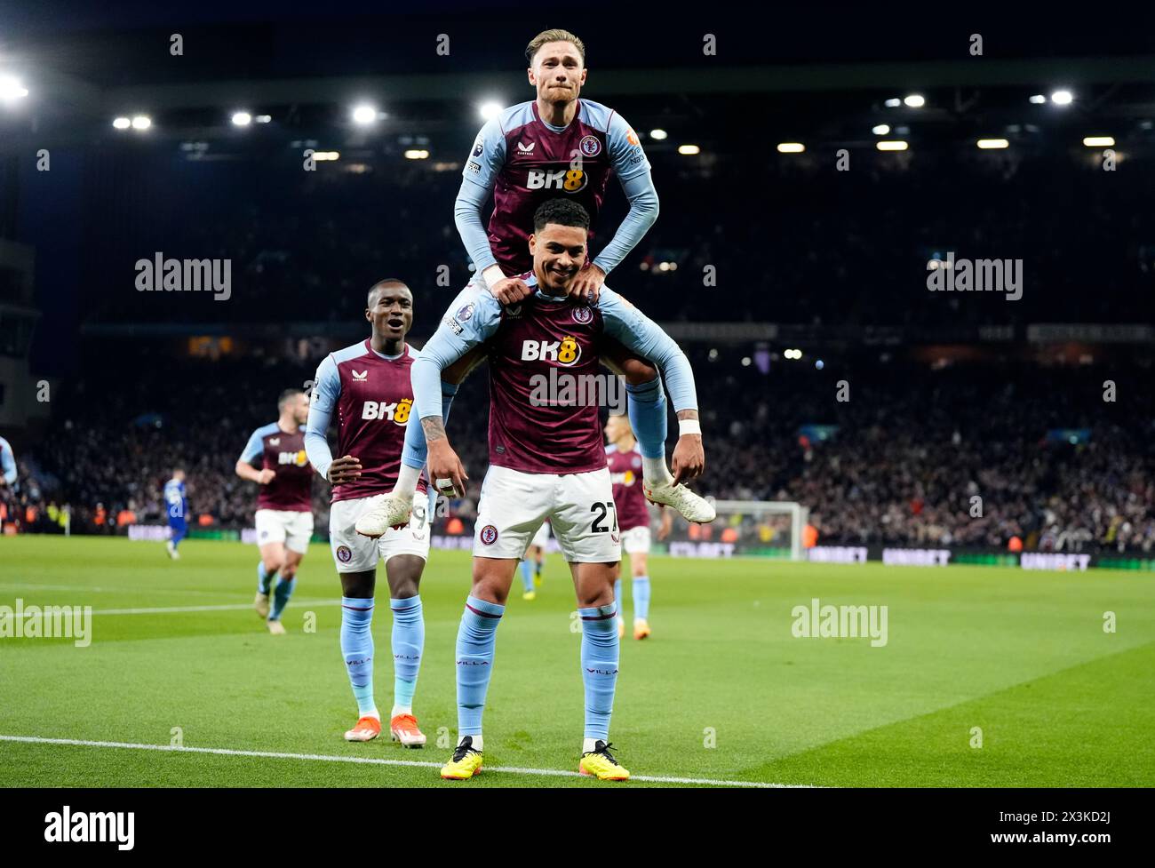 Aston Villa's Morgan Rogers (bottom) celebrates scoring their side's second goal of the game with team-mates during the Premier League match at Villa Park, Birmingham. Picture date: Saturday April 27, 2024. Stock Photo