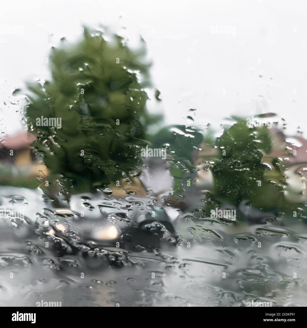 Blurred view of road through wet car window. Rainy weather. Safety ...