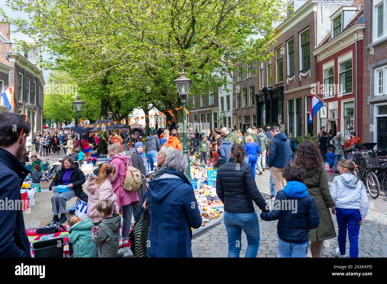 April 27, 2024, Leiden, Netherlands,  A busy day in the city center of the city during King's day. People are buying things kids toys and muffins. Stock Photo