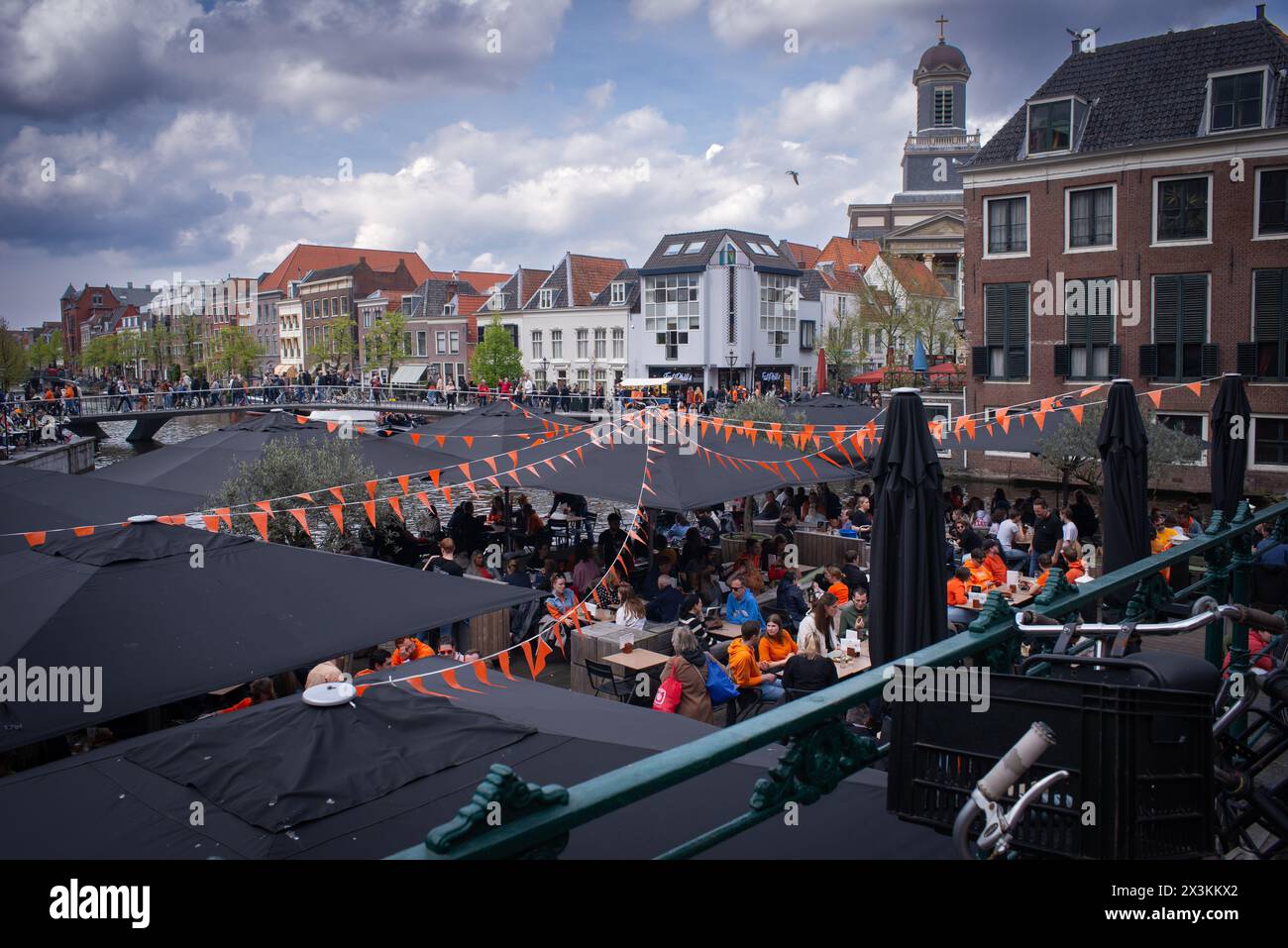 April 27, 2024: Leiden, Netherlands, Canals party celebration the birthday of the King in Netherlands, National holiday King’s Day or Koningsdag in Du Stock Photo