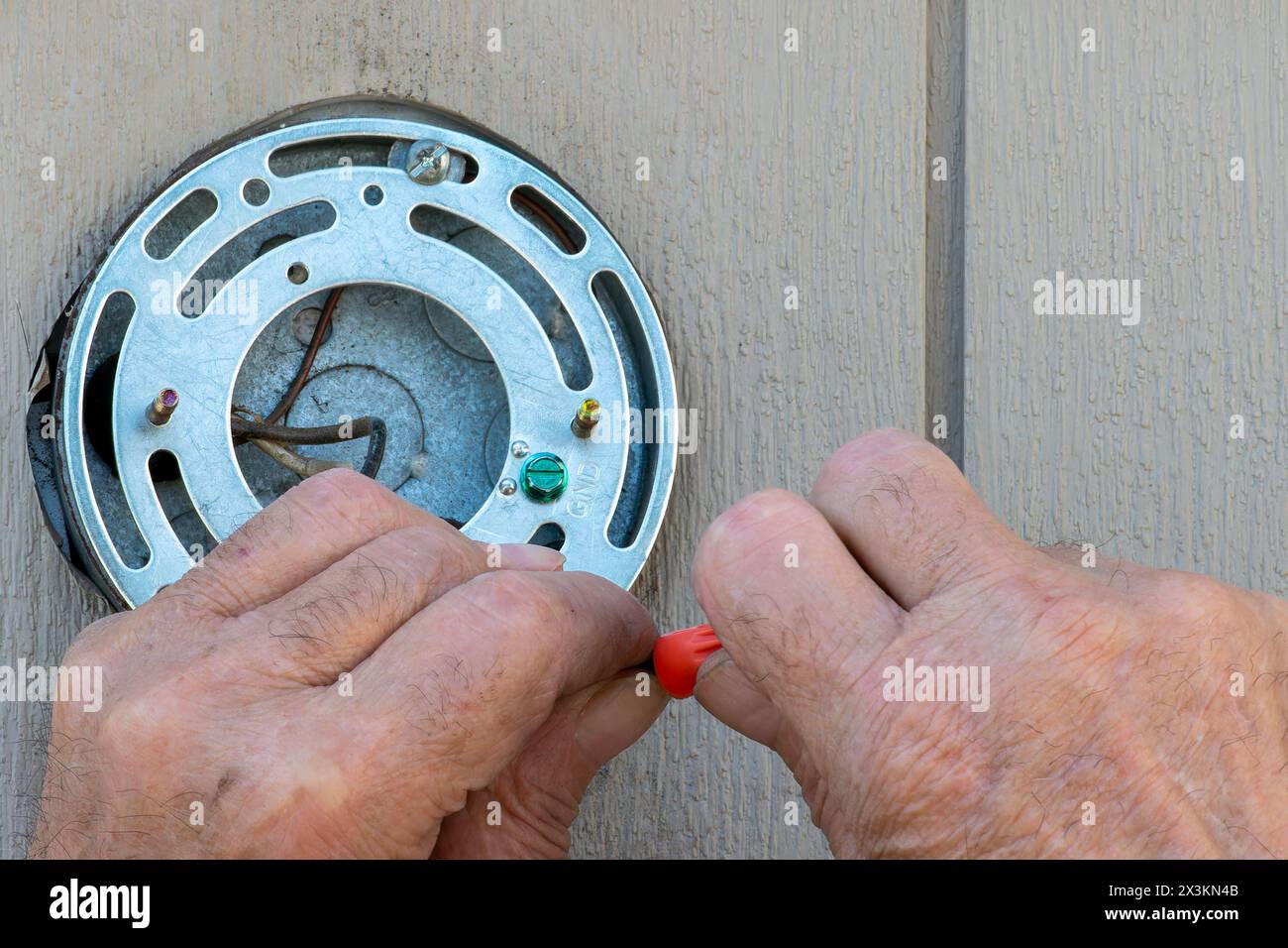 Hands of an Older man doing electrical work Stock Photo