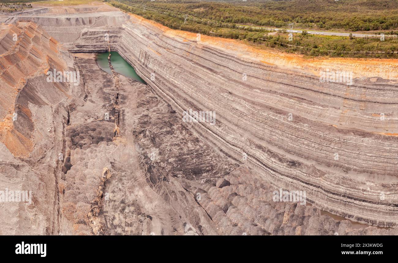 Corner of deep open pit excavated mine in Hunter valley of Australia - aerial panorama. Stock Photo