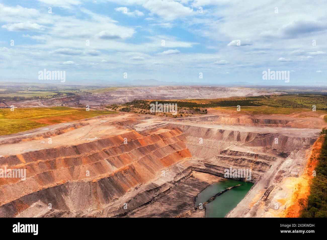 Aerial industrial view of open pit deep excavated mine in Hunter Valley of Australia. Stock Photo