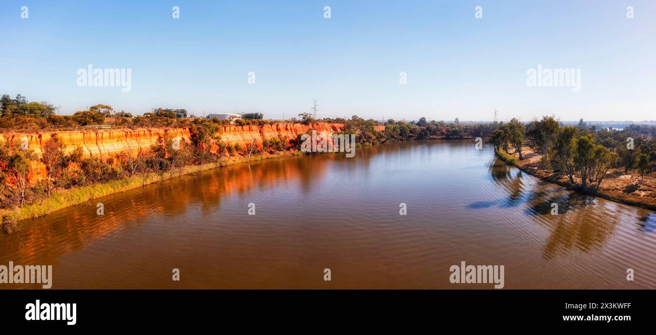 Scenic red cliffs of clay on shores of Murray river at Mildura town on Victoria - NSW border of Australia - aerial panorama. Stock Photo