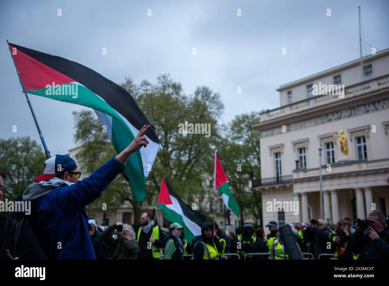 London, UK. 27th Apr, 2024. An activist holds a large Palestinian flag during the National March for Palestine Protest. The Palestine Solidarity Campaign organised a march from Parliament Square to Hyde Park, London to demand UK government stop arming Israel and call for a permanent ceasefire. Credit: SOPA Images Limited/Alamy Live News Stock Photo