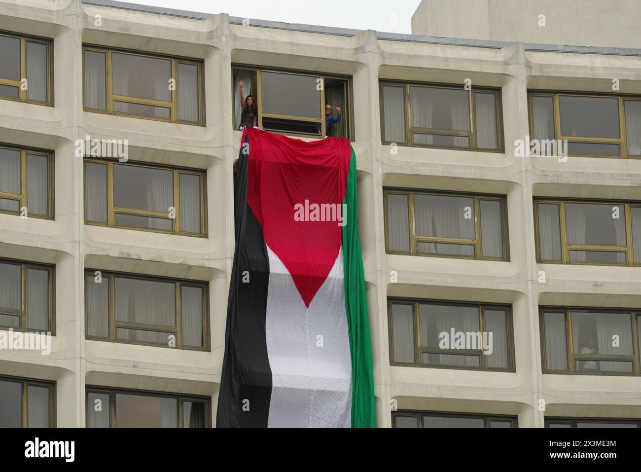 Washington, DC, USA. 27 Apr 2024. Protesters unfurl a giant Palestinian flag out of a window at the Washington Hilton during the annual White House Correspondence Dinner. Credit: Philip Yabut/Alamy Live News Stock Photo