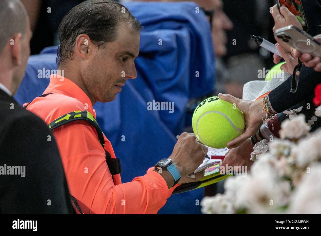 Madrid, Spain. 27th Apr, 2024. Rafael Nadal signs autographs for his fans after his victory over Álex de Miñaur at the Caja Magica in Madrid. The Spanish tennis player Rafael Nadal defeated the Australian Álex de Miñaur at the Mutua Madrid Tenos Open with partial scores of 7-6 and 6-3. The Spaniard's victory is worth him to face the Argentine Pedro Cachín on Monday. Credit: SOPA Images Limited/Alamy Live News Stock Photo
