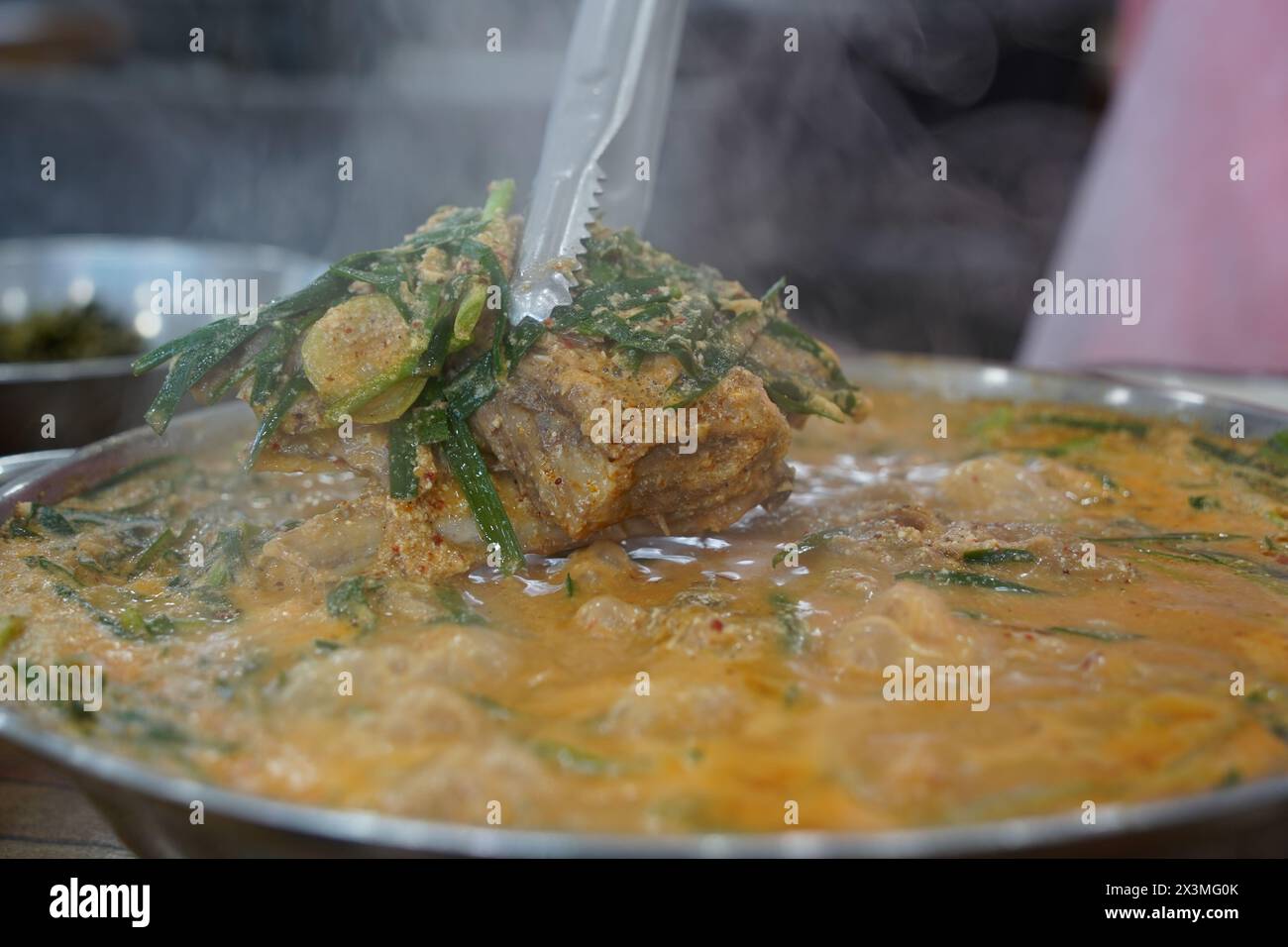 Korean traditional food. Pork Back-bone Stew is a thick traditional Korean food made with pork spine, potatoes, and various vegetables. Stock Photo