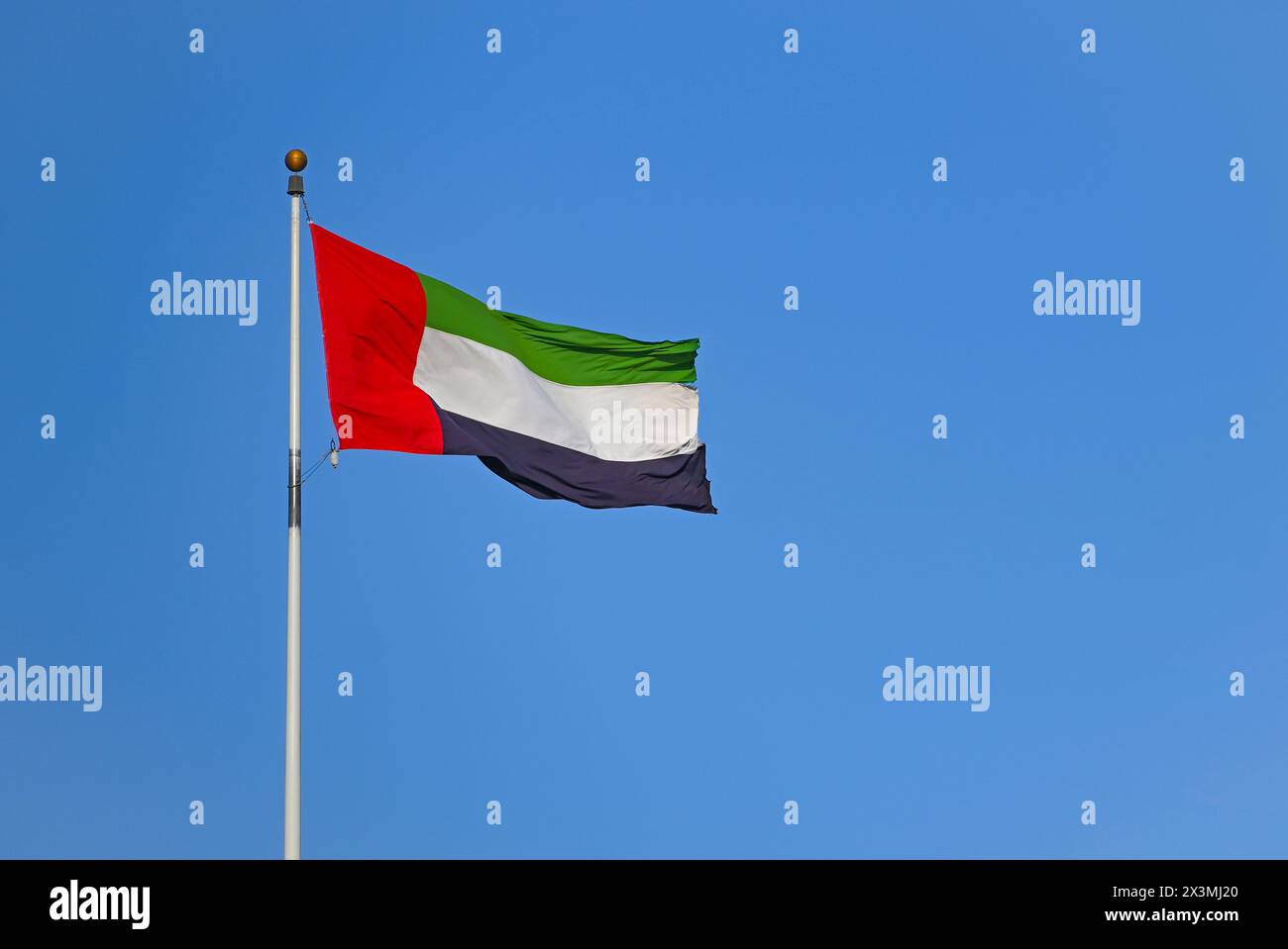 Flag of United Arab Emirates against blue sky Stock Photo