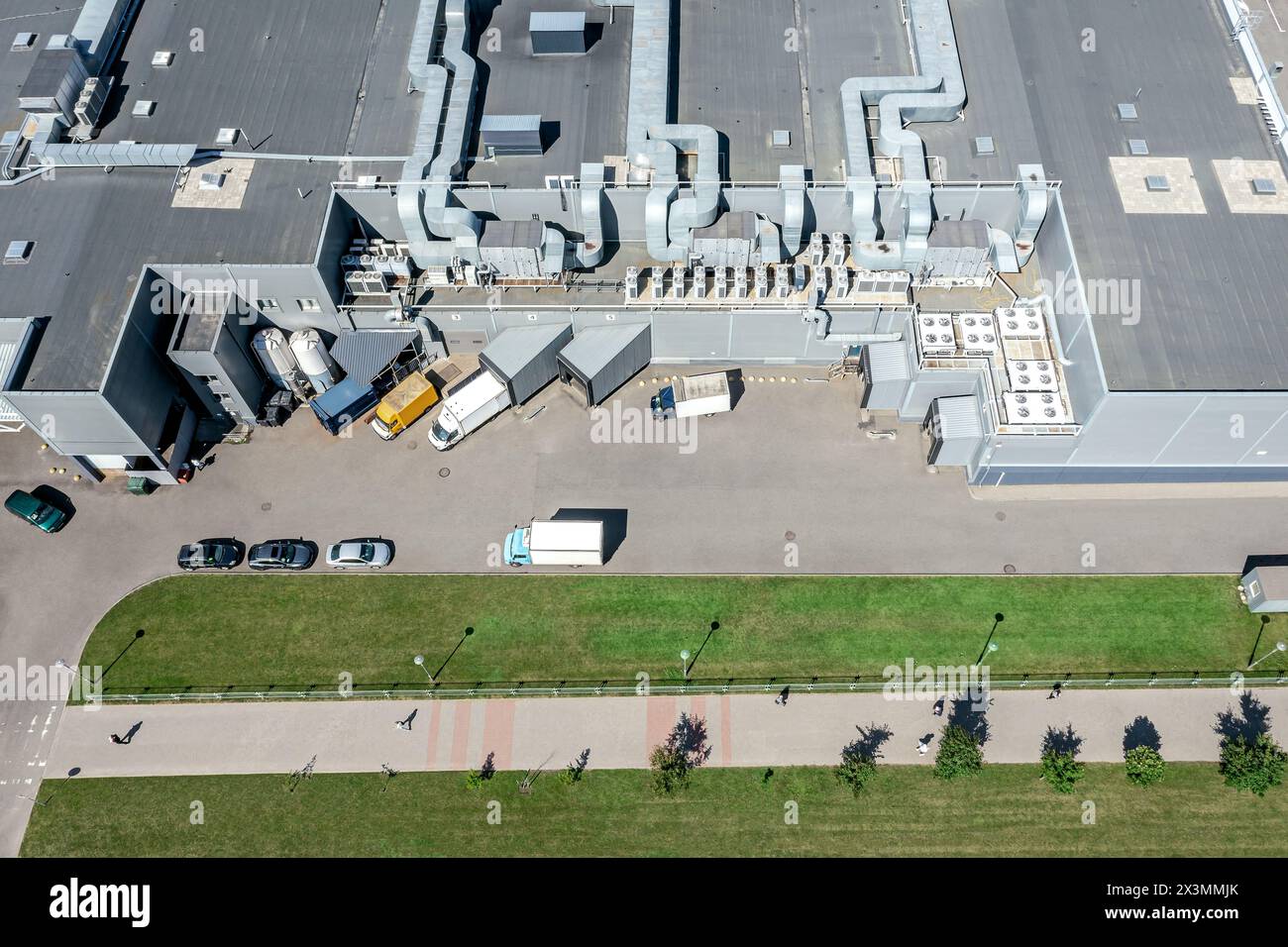shopping mall with trucks unloading goods for further retail sale ...