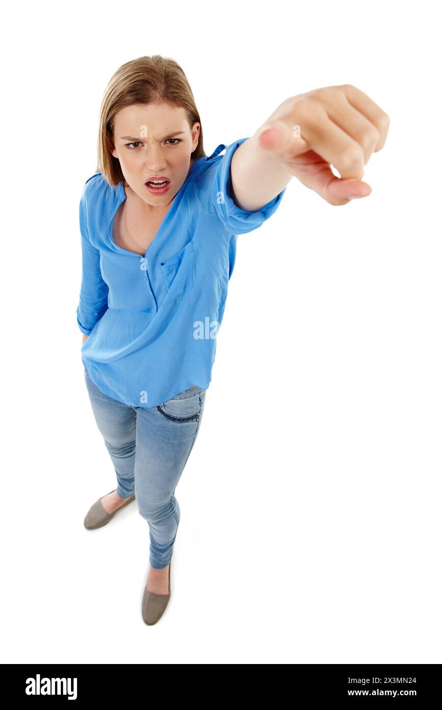 Angry, portrait and girl with hand pointing at you in studio top view for choice, direction and accountability on white back. Hey, face and gen z Stock Photo