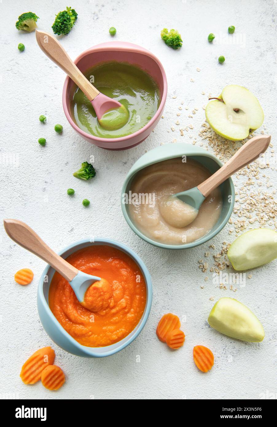 Healthy baby food in bowls. Various bowls of fruit and vegetable puree ...