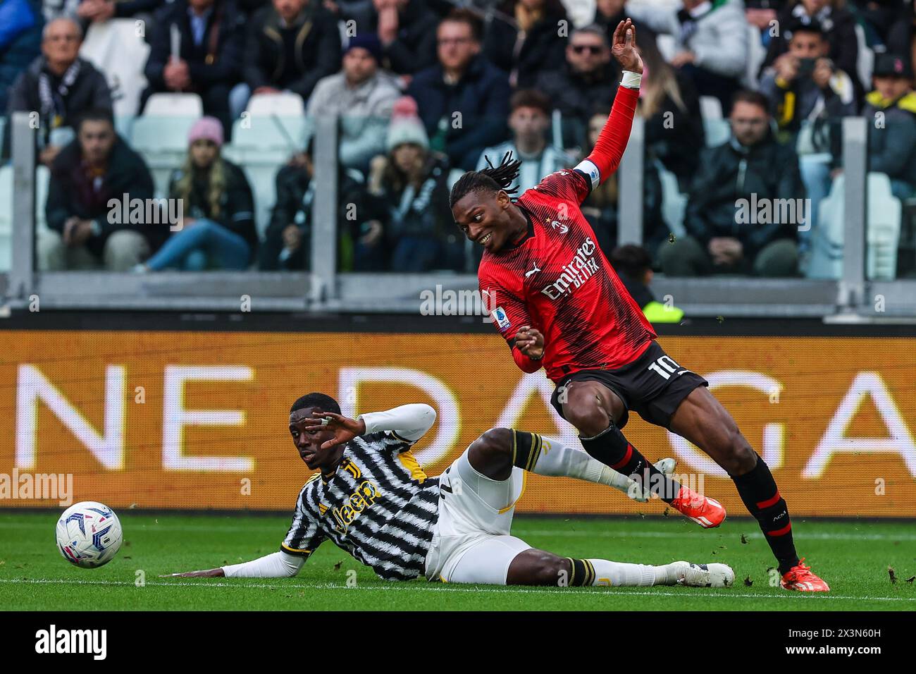 Turin, Italy. 27th Apr, 2024. Rafael Leao of AC Milan (R) with Timothy Weah of Juventus FC (L) seen in action during the Serie A 2023/24 football match between Juventus FC and AC Milan at Allianz Stadium. Final score; Juventus 0;0 Milan Credit: SOPA Images Limited/Alamy Live News Stock Photo