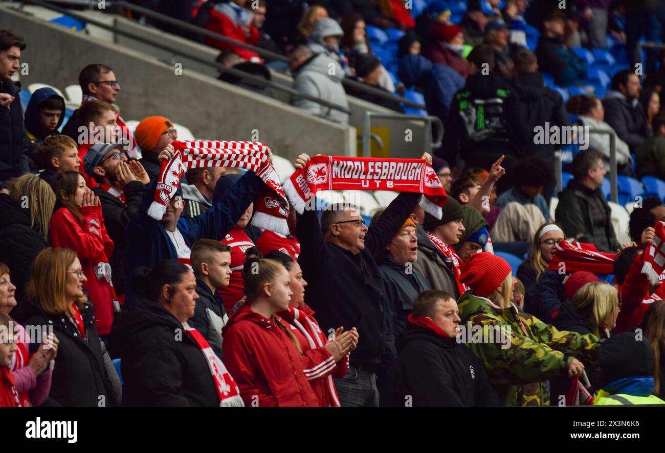 Middlesbrough United FC fans hold their scarves up at the beginning of their game against Cardiff City in support of their team. Cardiff City Stadium. Stock Photo