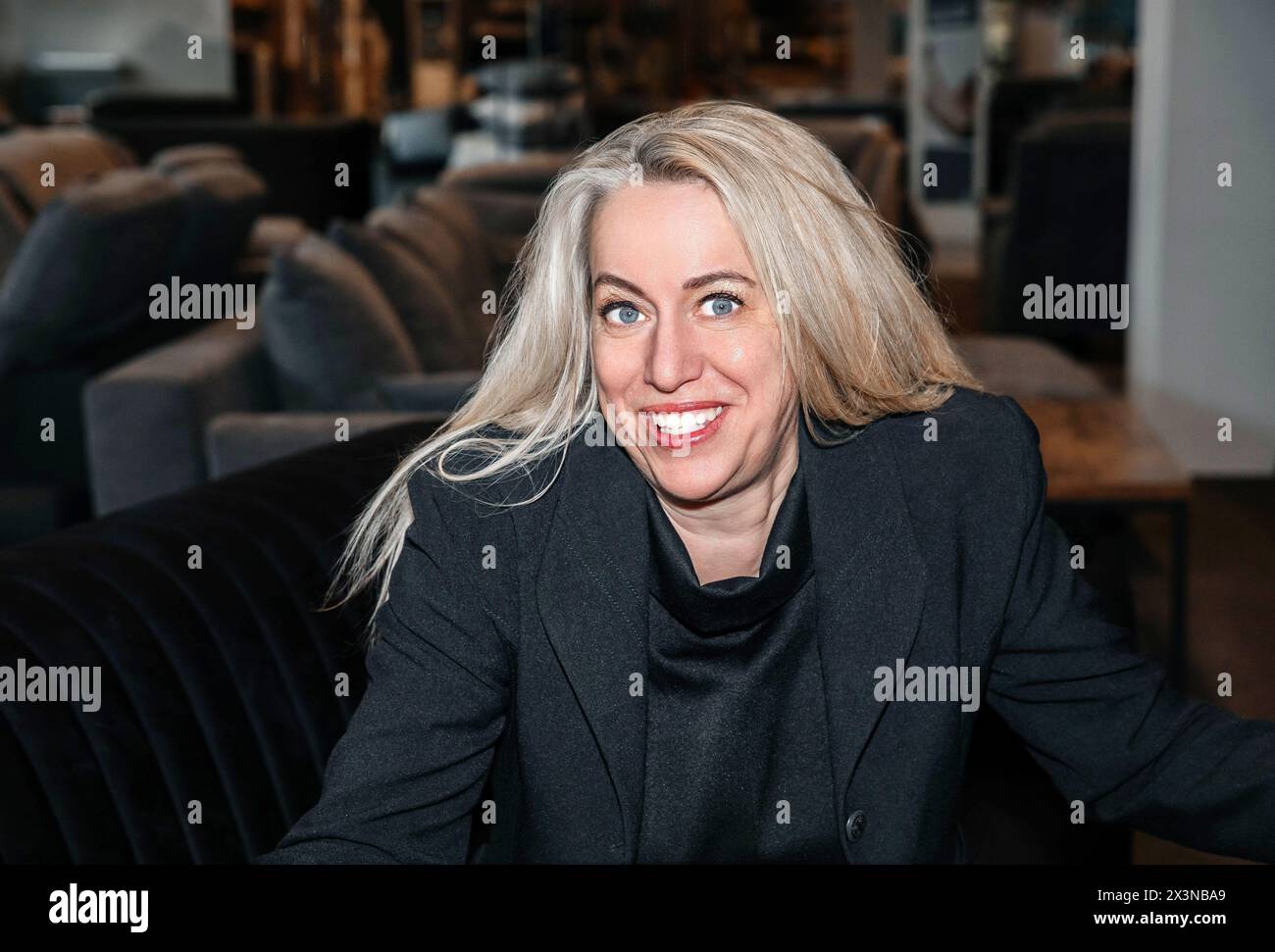 Radiant mature lady with silver hair, exuding charisma in a formal black ensemble Stock Photo
