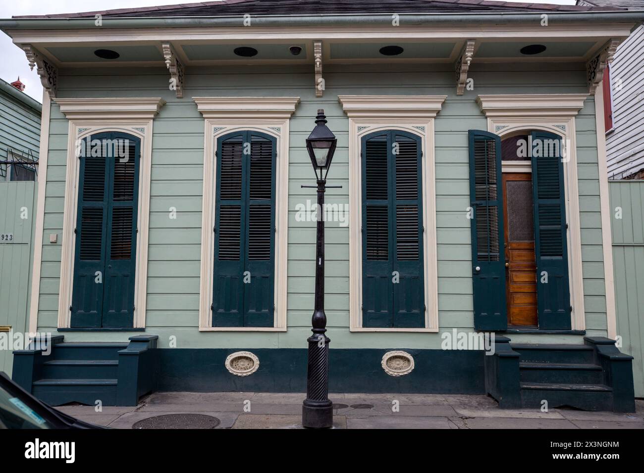 French Quarter, New Orleans, Louisiana.  A Double Shotgun House with Pair of Windows Flanked by Entrance Doors.  Duplex. Stock Photo