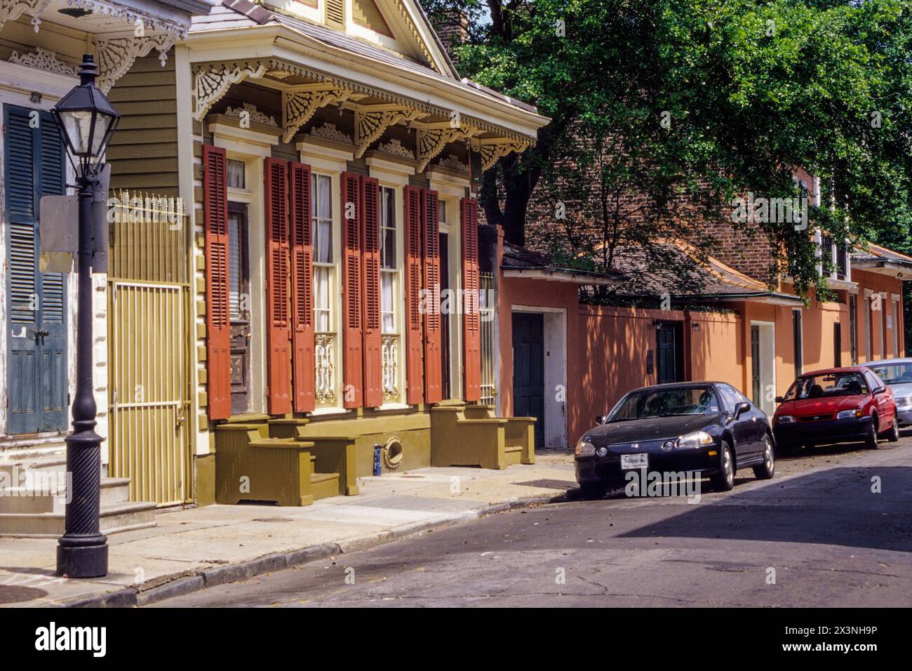 New Orleans, Louisiana. French Quarter. Double Shotgun-Style House.  Duplex.  Two Doors, Two Windows.  Italianate Brackets Supporting front overhang. Stock Photo