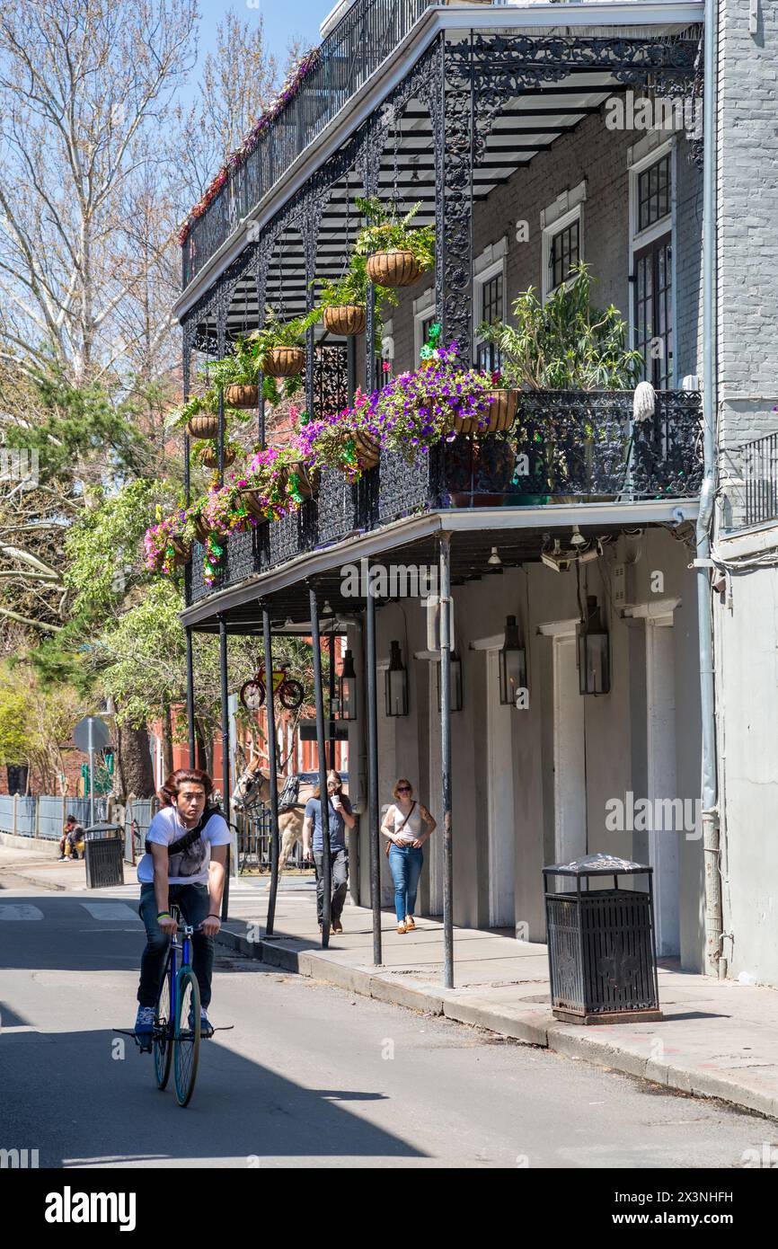 French Quarter, New Orleans, Louisiana.  Balcony with Petunias and Hanging Flower Baskets. Stock Photo