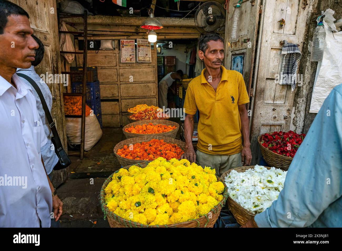 Mumbai, India - February 23, 2024: A man selling flowers at the Dadar Flower Market in Mumbai, India. Stock Photo