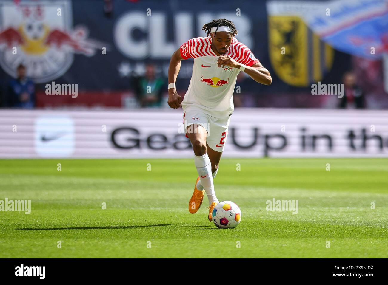 Leipzig, Germany. 27th Apr, 2024. Soccer: Bundesliga, RB Leipzig - Borussia Dortmund, Matchday 31 at the Red Bull Arena. Leipzig player Mohamed Simakan on the ball. Credit: Jan Woitas/dpa - IMPORTANT NOTE: In accordance with the regulations of the DFL German Football League and the DFB German Football Association, it is prohibited to utilize or have utilized photographs taken in the stadium and/or of the match in the form of sequential images and/or video-like photo series./dpa/Alamy Live News Stock Photo