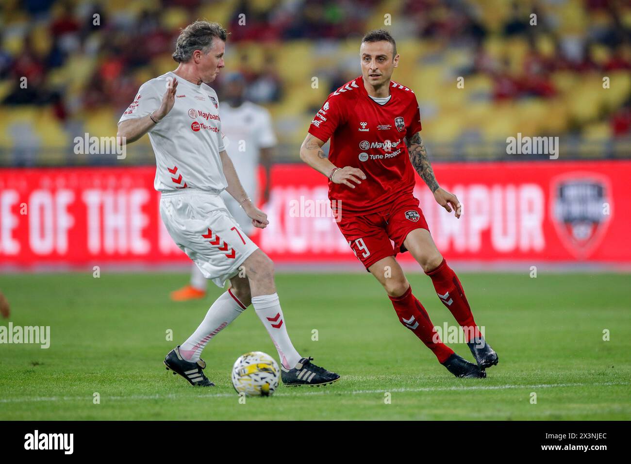 Kuala Lumpur, Malaysia. 27th Apr, 2024. Steve Mcmanaman of Liverpool Reds (L) and Dimitar Berbatov of Manchester Reds seen in action during the 'Battle of the Reds 2024' match between Manchester United and Liverpool legends at National Stadium Bukit Jalil. Final score; Liverpool Reds 4:2 Manchester Reds. Credit: SOPA Images Limited/Alamy Live News Stock Photo