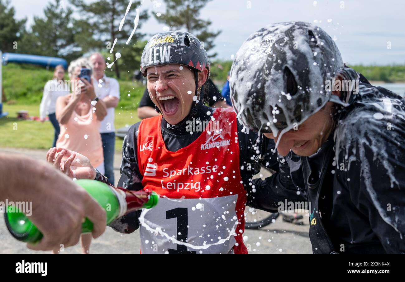Markkleeberg, Germany. 28th Apr, 2024. Canoeing: German Olympic qualification canoe slalom, women's canoe, final. Elena Lilik (l) and Noah Hegge are celebrated with champagne for their successful Olympic qualification campaign. Lilik was preceded by Hegge in the K1 final. Credit: Hendrik Schmidt/dpa/Alamy Live News Stock Photo