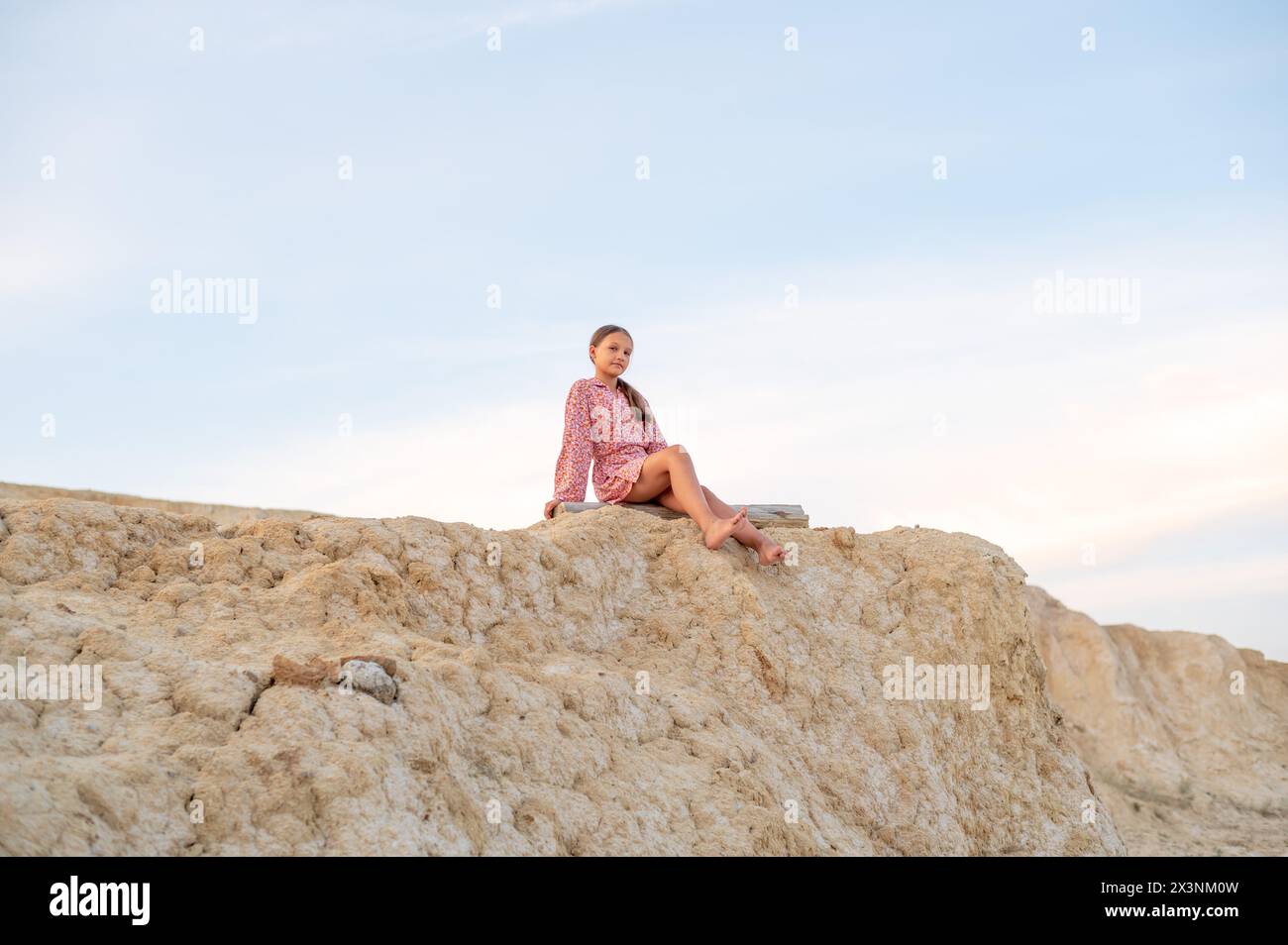 Teenager girl resting in nature, portrait girl sitting on the edge of a ...