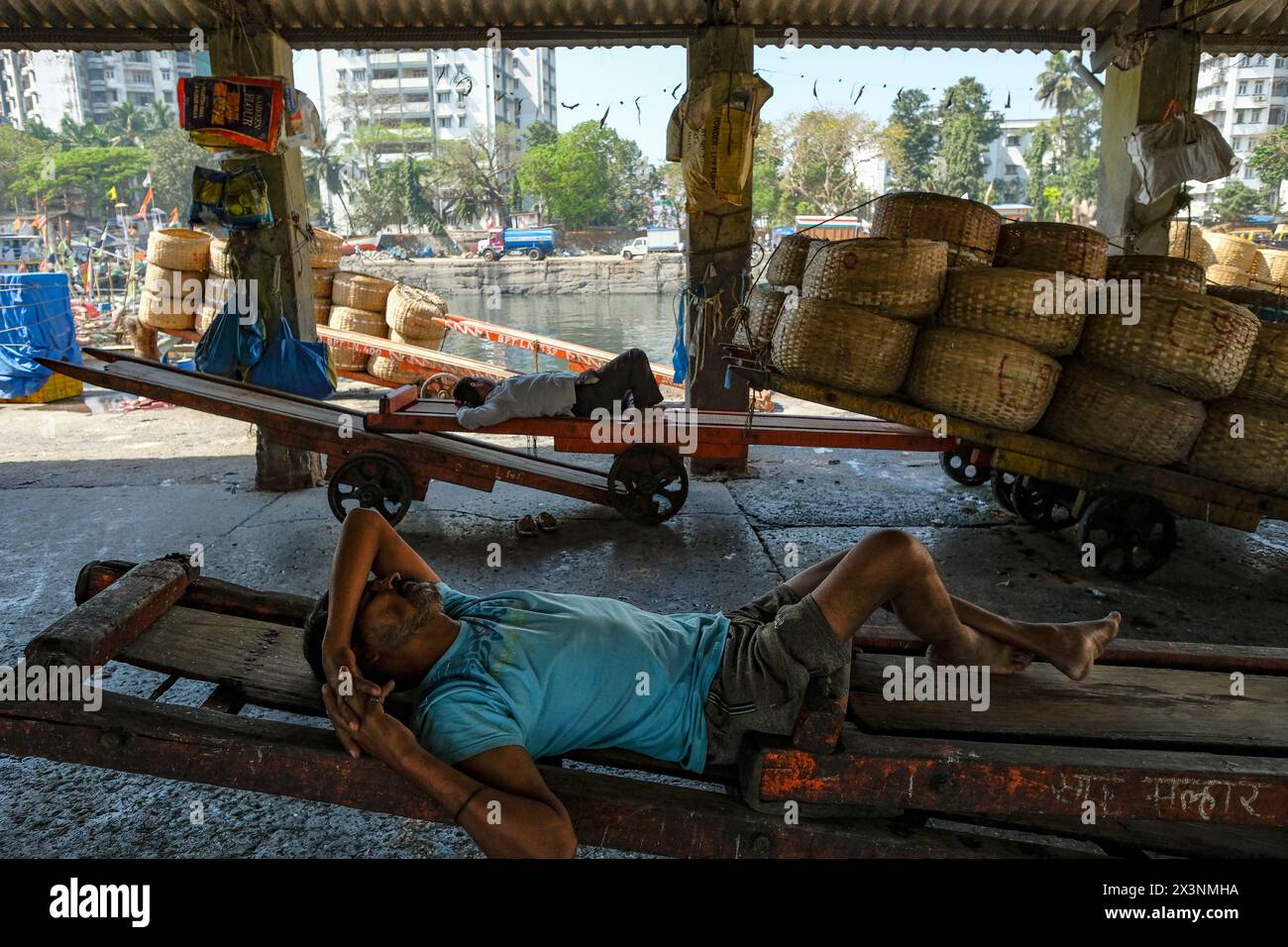 Mumbai, India - March 8, 2024: Fishermen resting at the Sassoon Dock in the Colaba district of Mumbai, India. Stock Photo